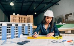african-american-woman-safety-helmet-working-near-model-building (1)